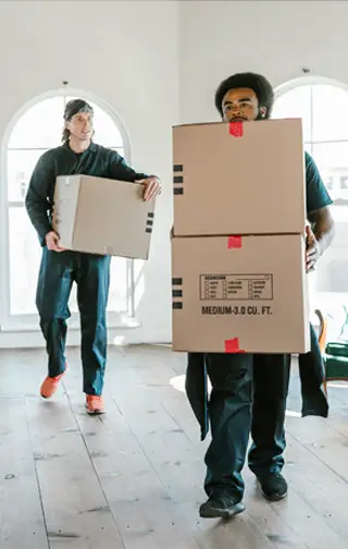 two men from a moving company moving boxes